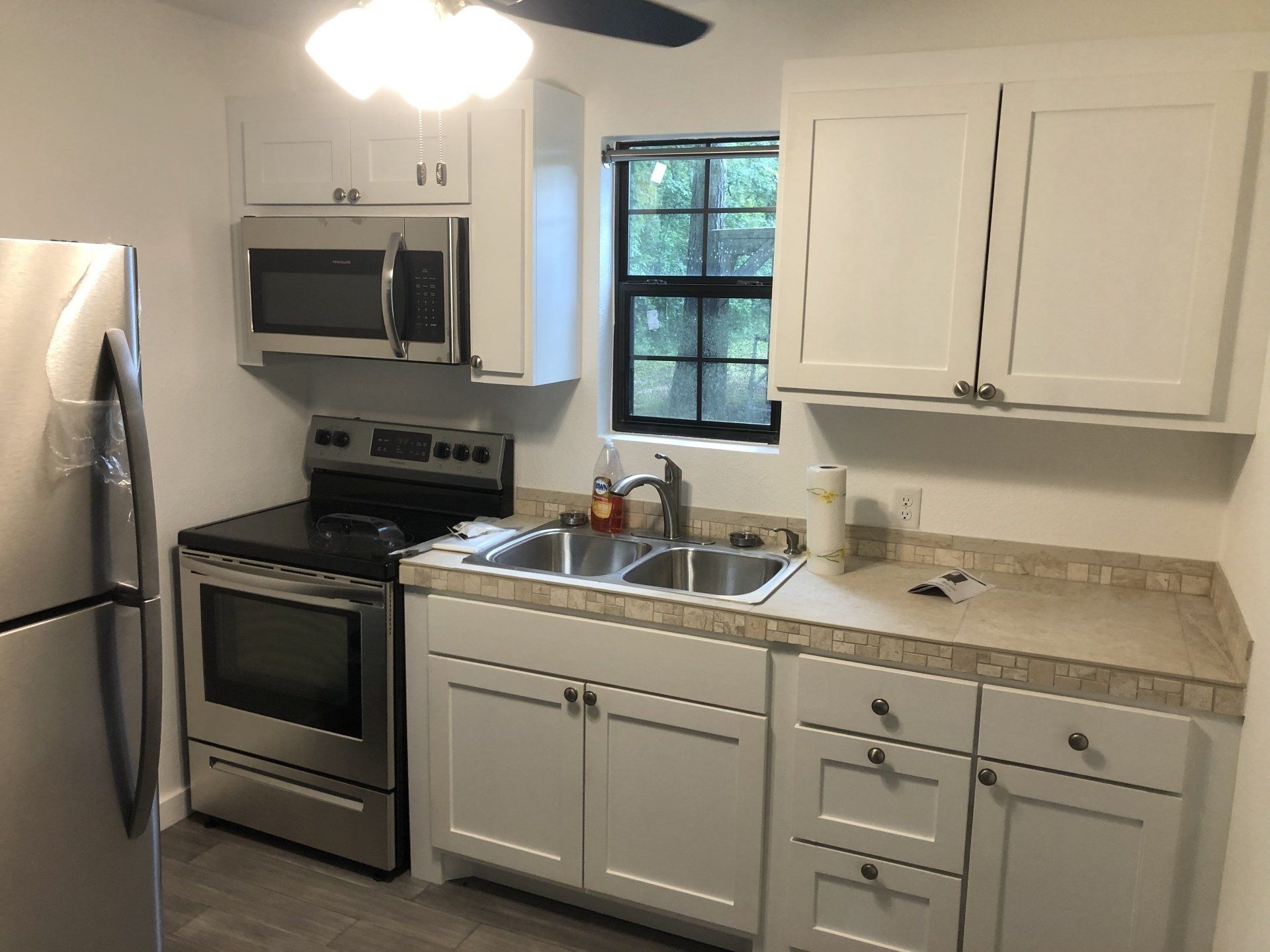 A kitchen with stainless steel appliances and white cabinets