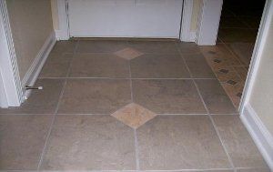 A hallway with a tiled floor and a door.