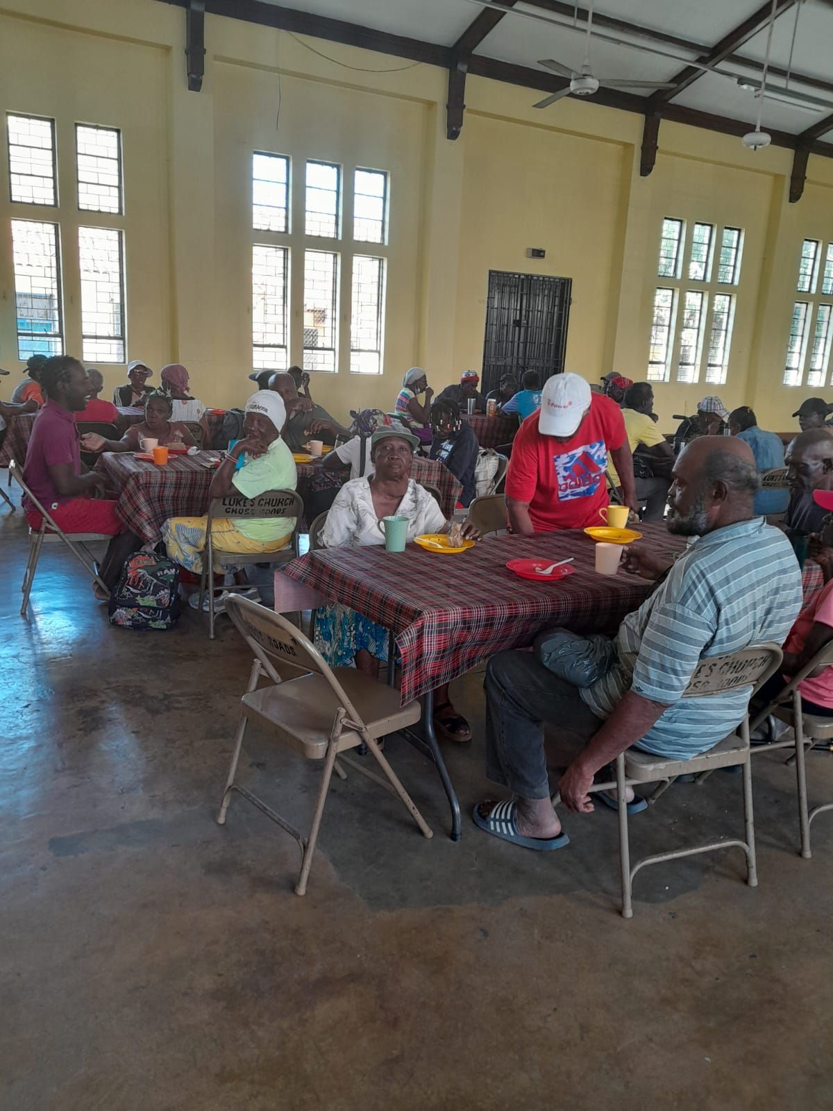 A group of people are sitting at tables in a large room