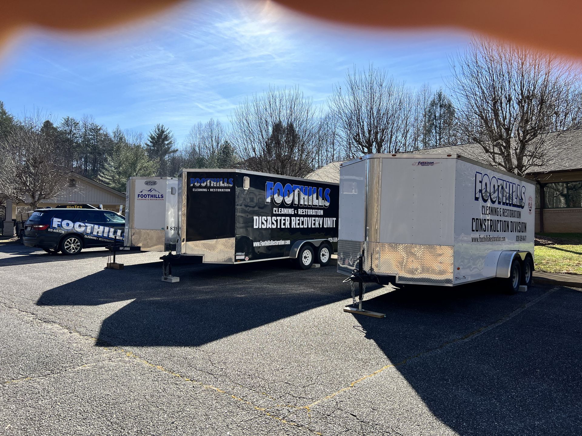 Three trailers parked outside, one labeled