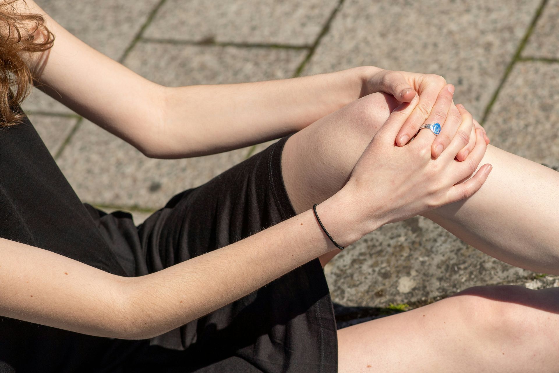 woman experiencing knee pain and holding her knee