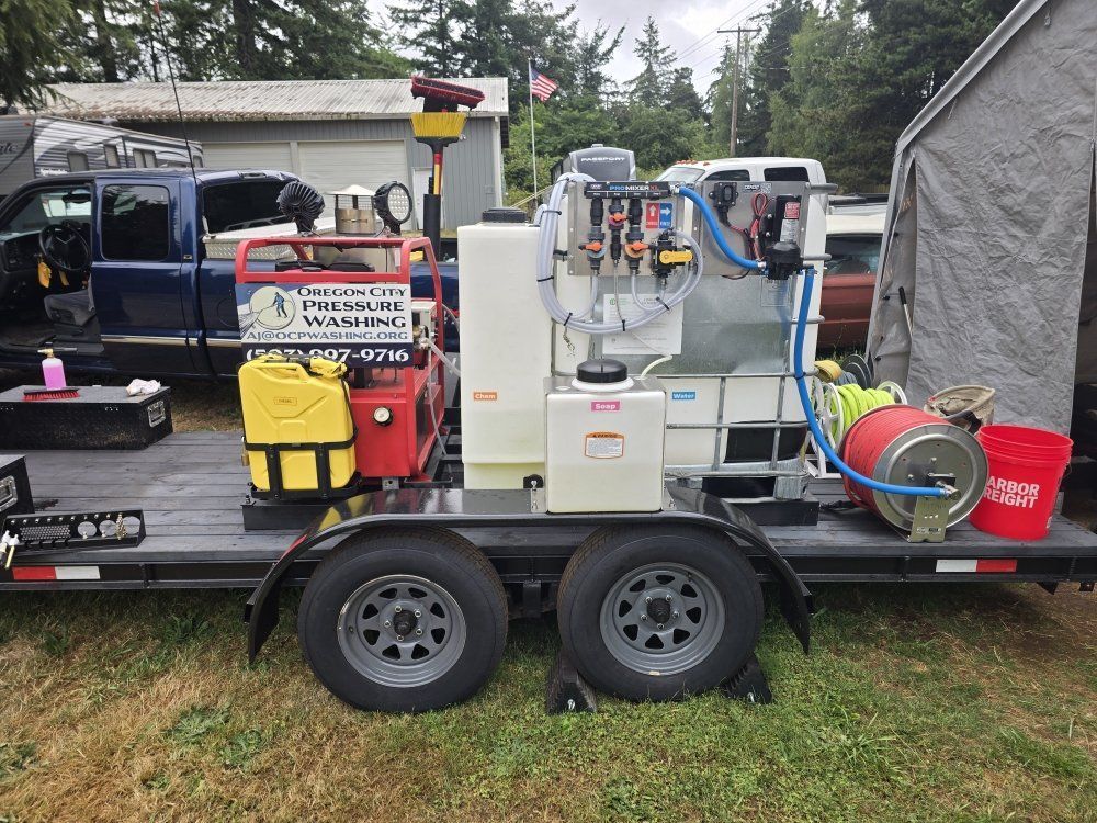 Portable pressure-washing trailer with tanks, hoses, and equipment parked outdoors