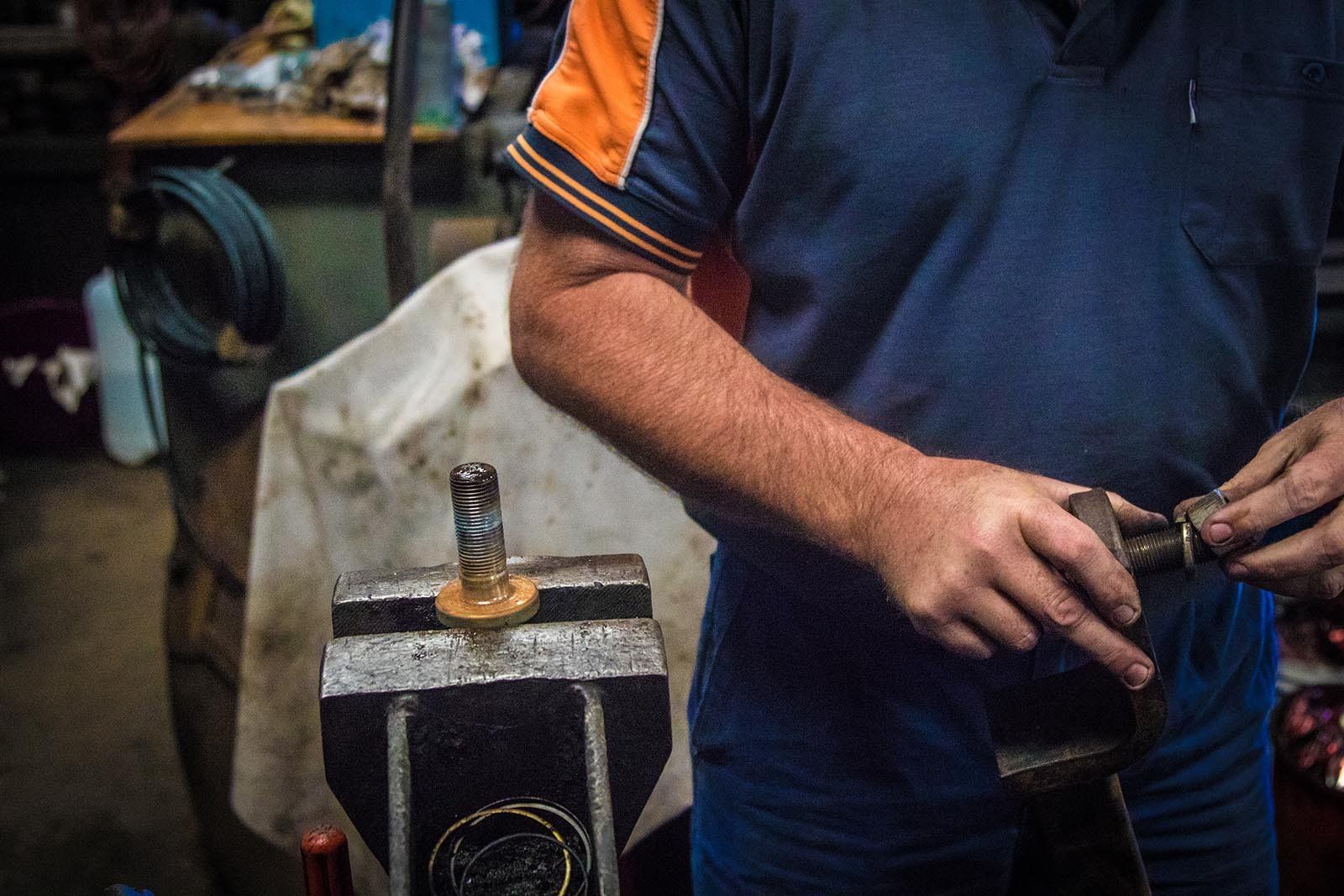 Mechanic Holding Car Part — Brake Service Specialists, NSW