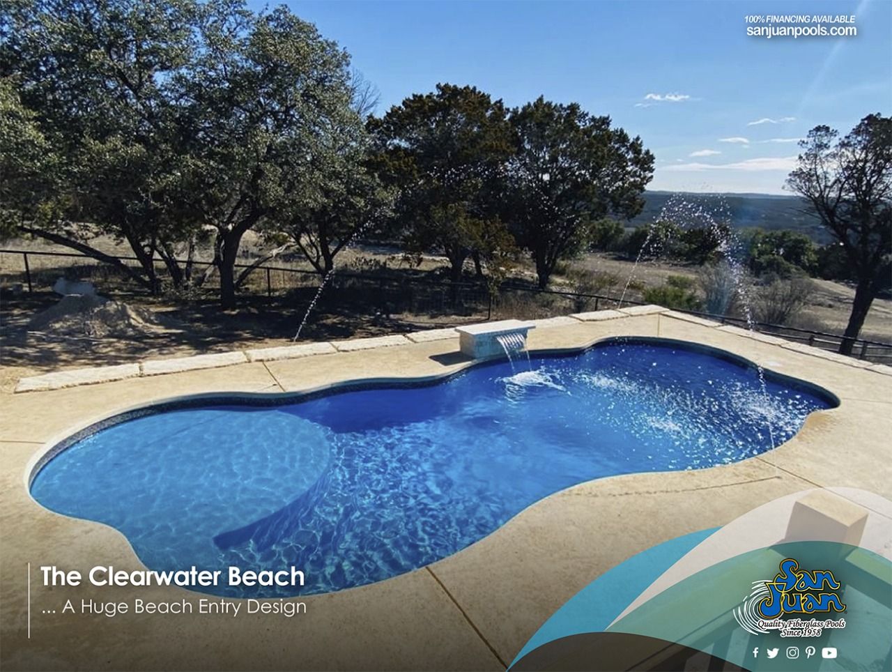 Outdoor resort pool with blue water, curved stone deck, and trees overlooking a scenic hillside.