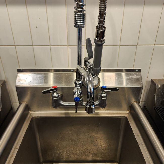 Commercial Sink, properly secured, caulked and new spout.