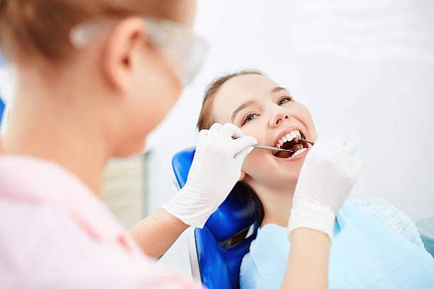 Female sitting at the dentists and having checkup
