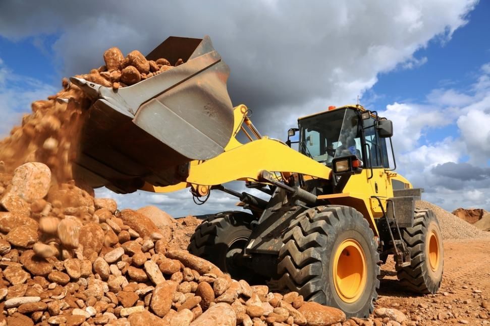 A Bulldozer is Loading Rocks Into a Bucket at a Construction Site — Zappala Quarries in Douglas Shire, QLD