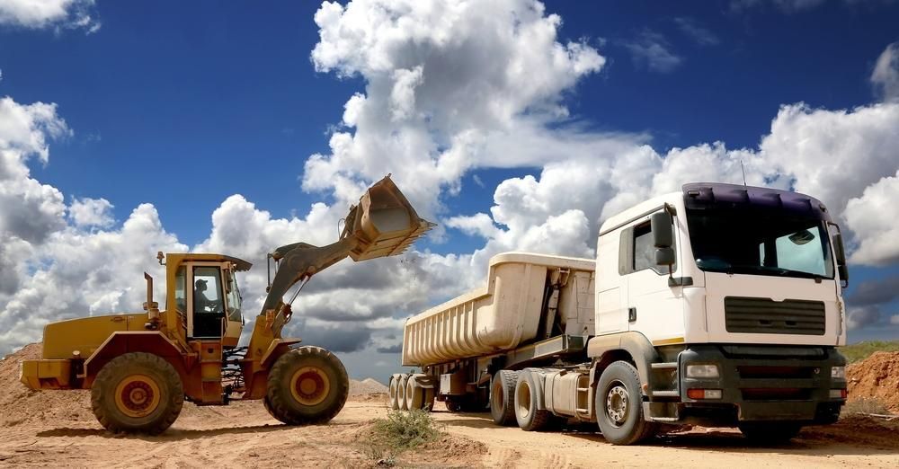 A Bulldozer Is Loading Gravel Into a Conveyor Belt at A Construction Site — Zappala Quarries in Tully, QLD