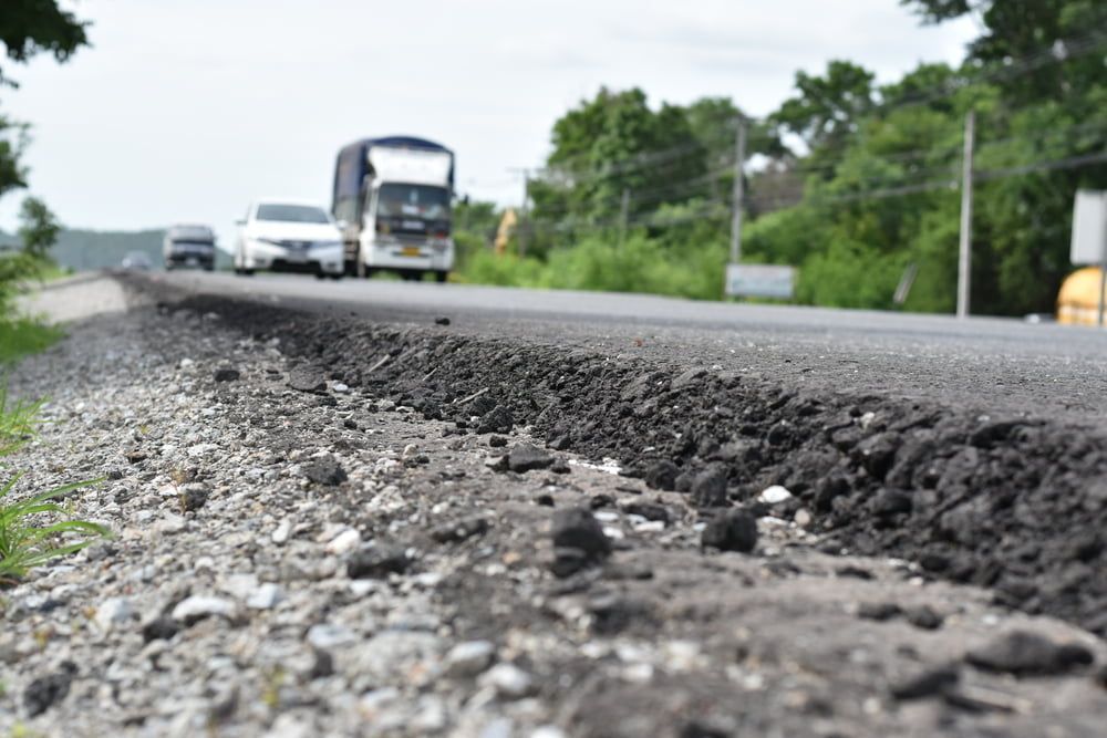A Truck Is Driving Down a Road Next to A Gravel Road — Zappala Quarries in Gordonvale, QLD