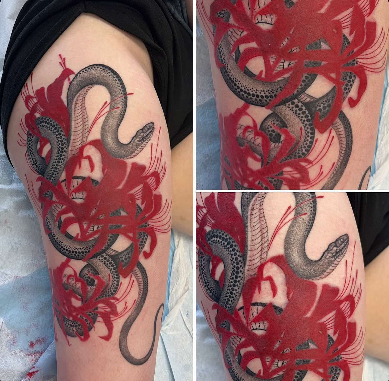 Tattoo of a snake entwined with red spider lilies, on a person's thigh.