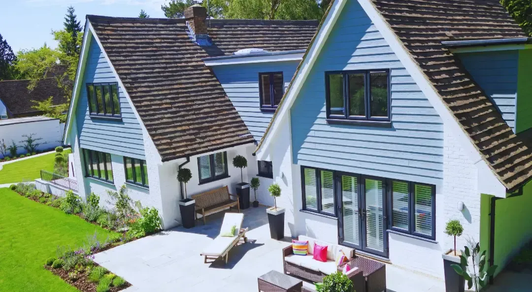 A couple of houses with a patio in front of them.