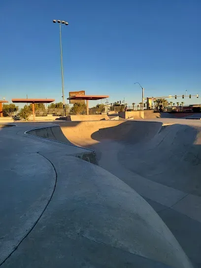 A skate park with a blue sky in the background