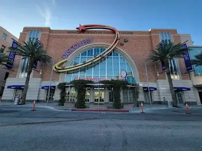 A large brick building with palm trees in front of it