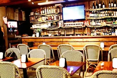 A restaurant with tables and chairs and a bar
