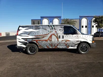 A van with a wrap on it is parked in front of a building.