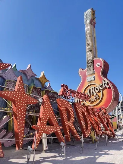 A hard rock sign with a guitar in the background
