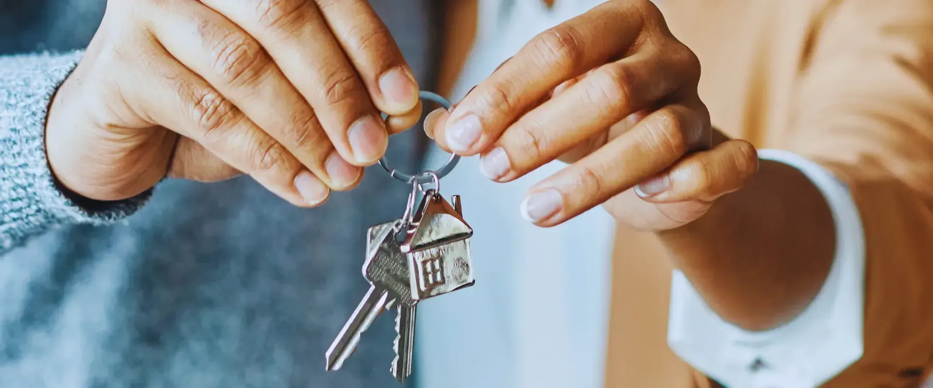 A person is holding a bunch of keys in their hands.