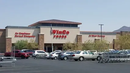 A vince foods store with cars parked in front of it