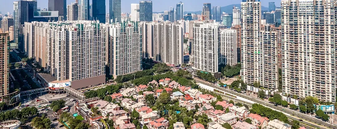 An aerial view of a city with lots of buildings and trees.