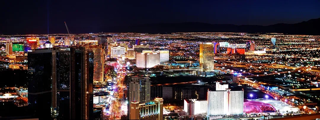 An aerial view of a city at night with lots of lights.