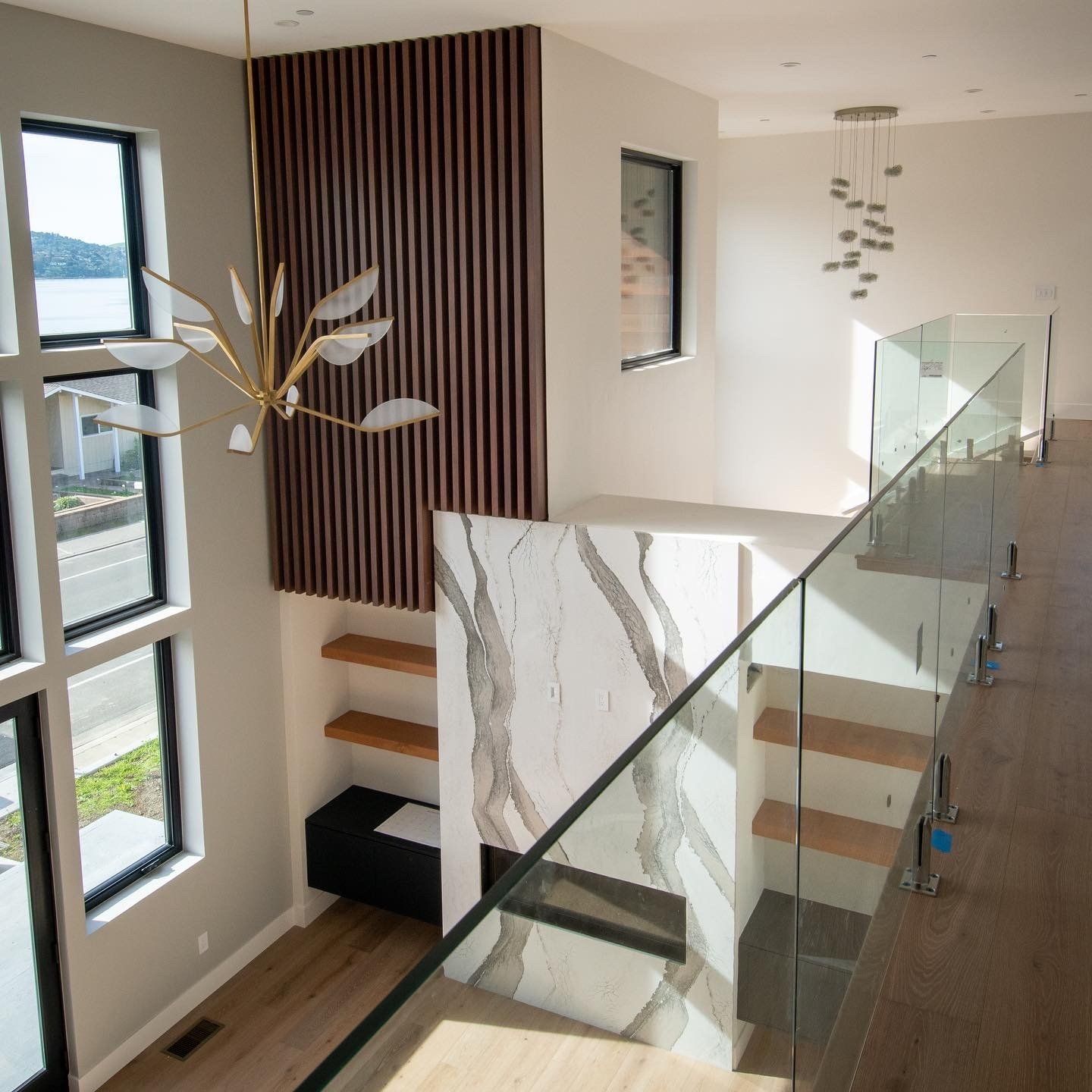 A view of a staircase from the second floor of a house.
