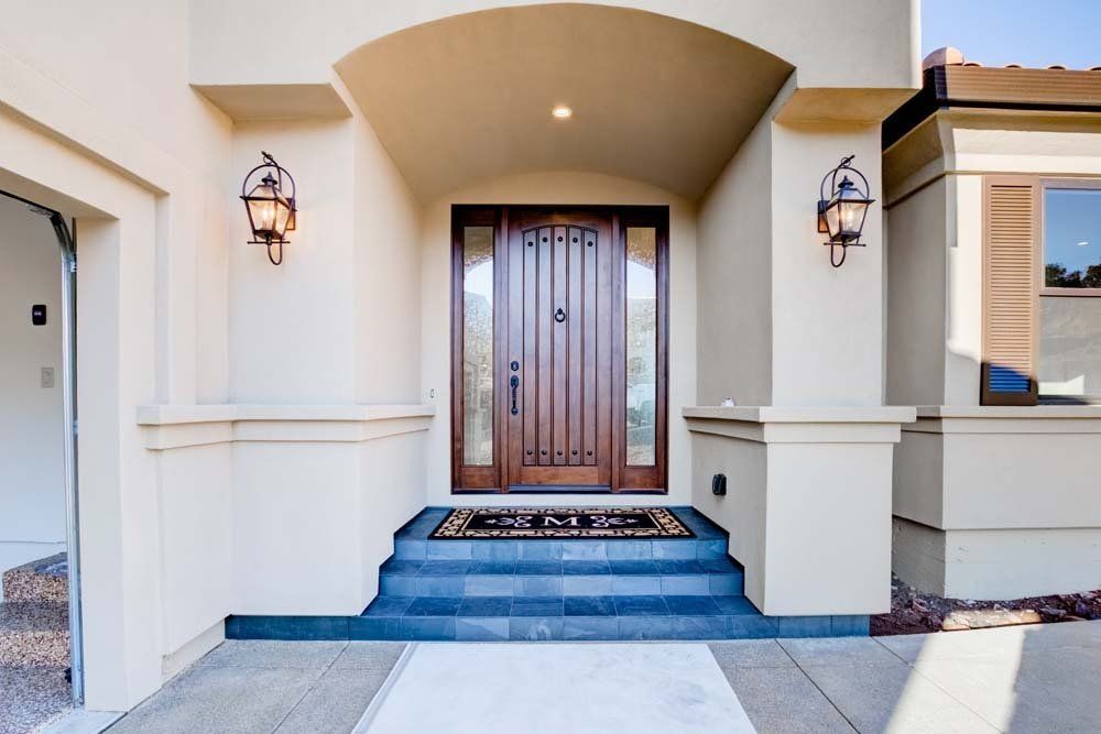 A white house with a wooden door and steps