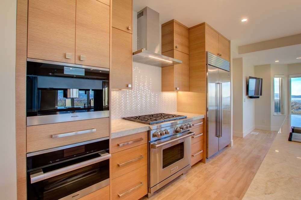 A kitchen with stainless steel appliances and wooden cabinets