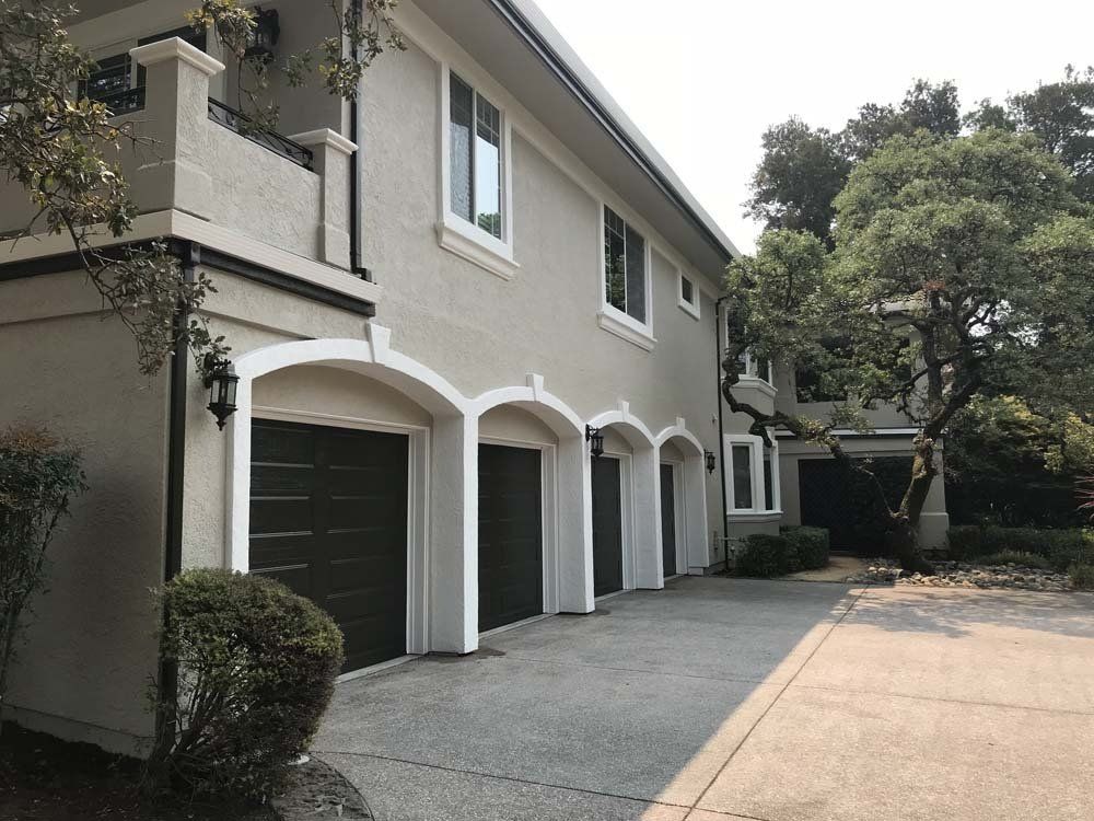 A house with a lot of garage doors and a driveway