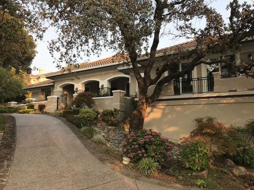 A large house with a tree in front of it