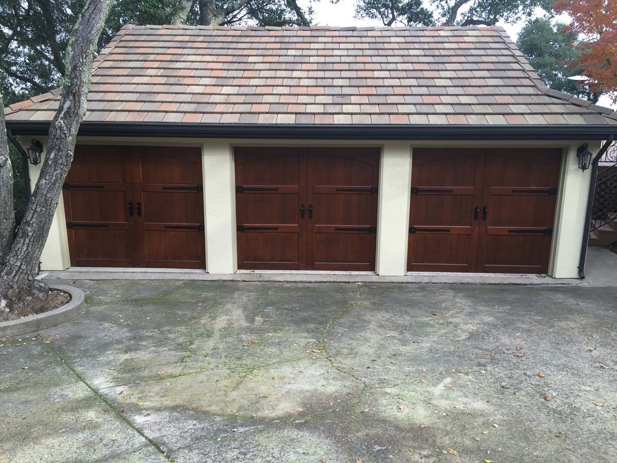 A garage with wooden doors and a tiled roof