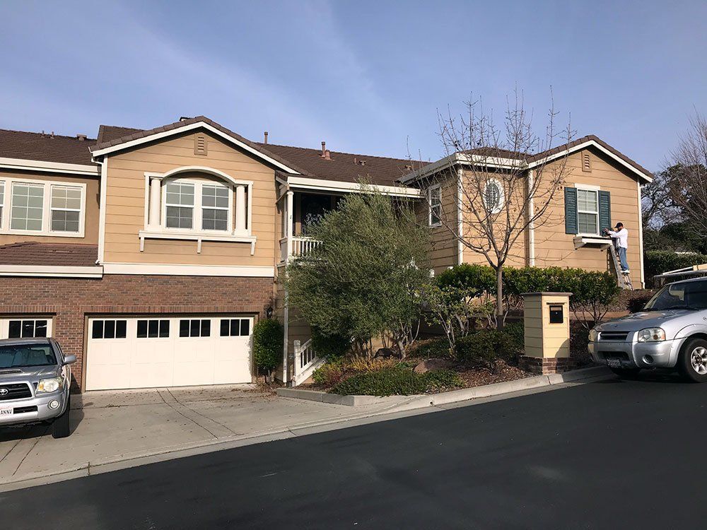 A large house with a car parked in front of it.