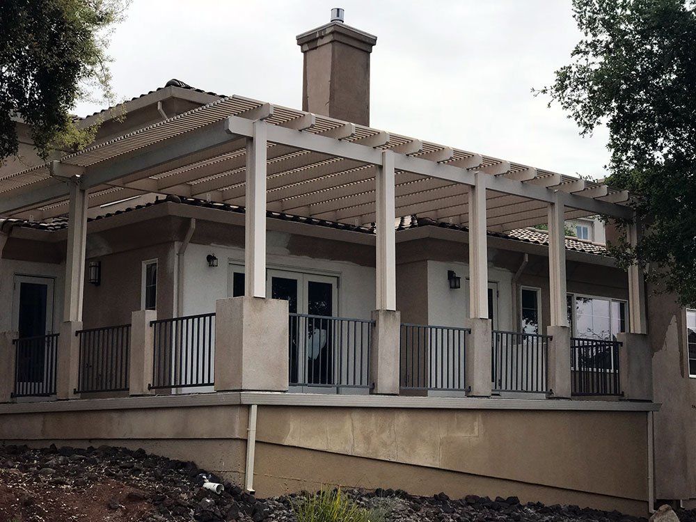 A house with a large porch and a chimney