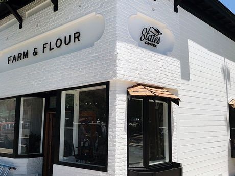 a white building with a sign that says farm & flour