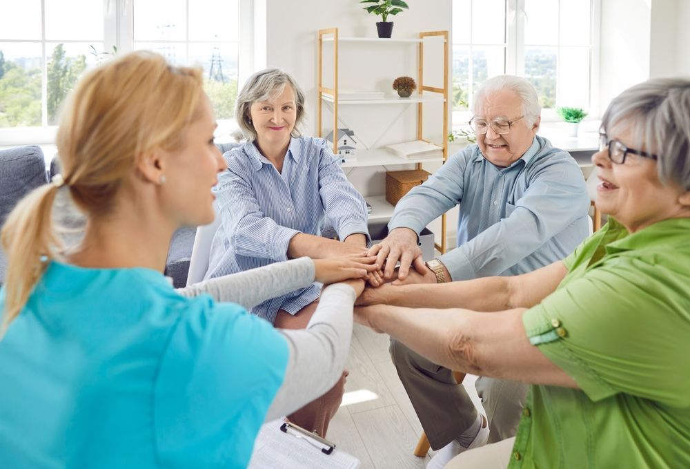 Senior people and care assistant team high five play