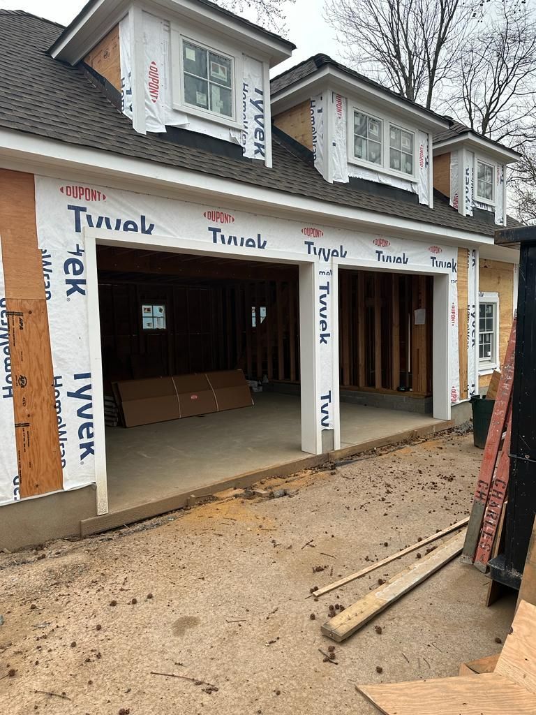 A house is being built with a large garage door.