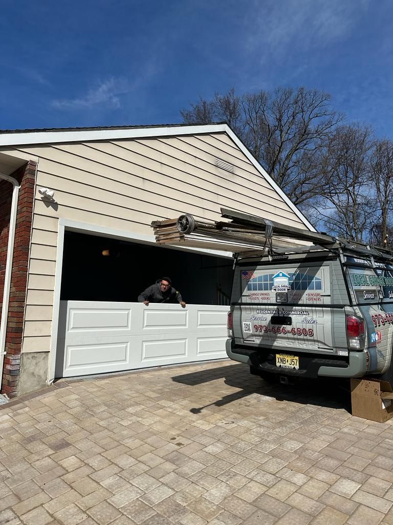 A truck is parked in front of a garage door.