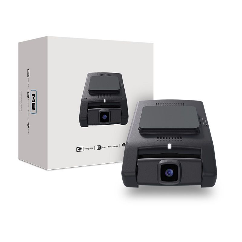 A dash cam is sitting next to a box.