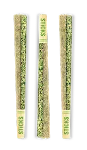 Three green packaged sticks in clear sleeves on a white background