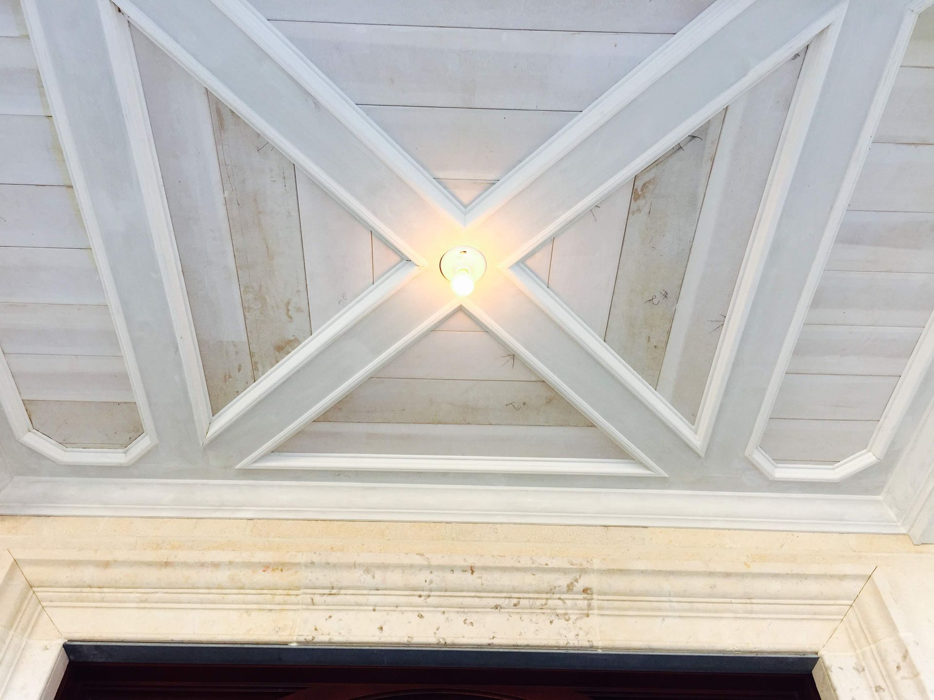 A white ceiling with a light shining through it