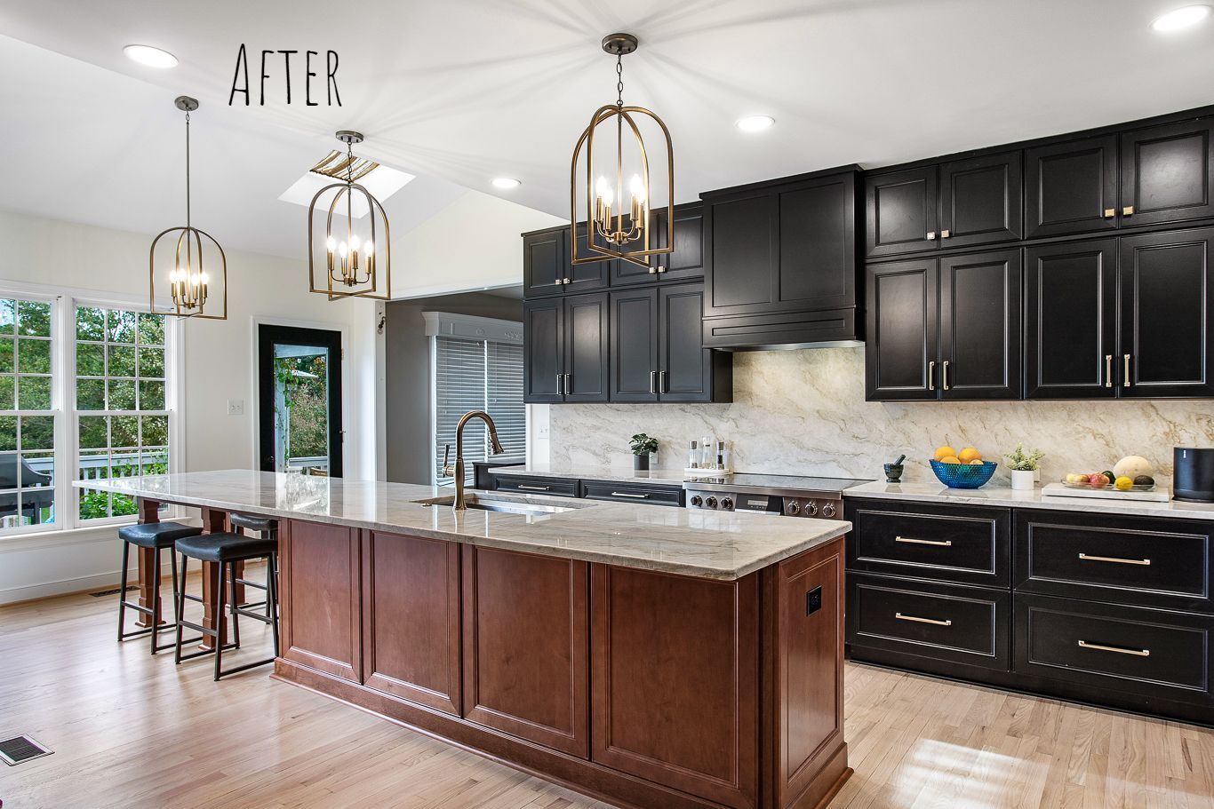 Kitchen Remodeling: A kitchen with black cabinets and a large island.