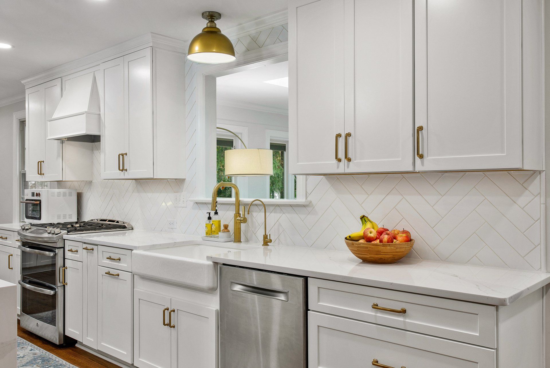 Kitchen Remodel: A kitchen with white cabinets and stainless steel appliances.
