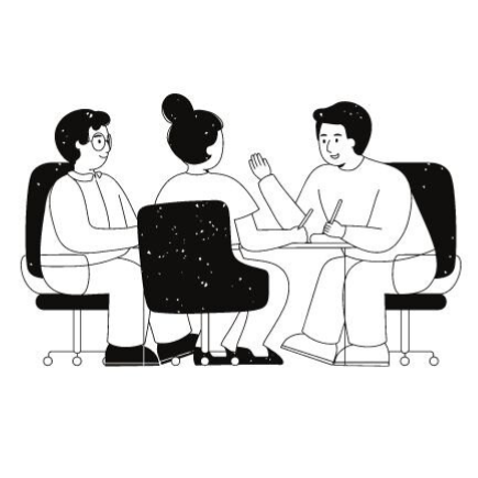 Three people seated in a meeting, one speaking and gesturing across a table