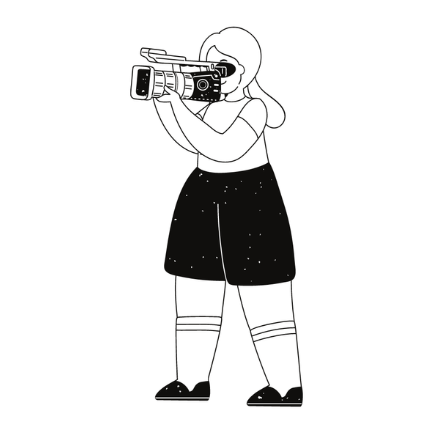 Person in a hijab filming with a handheld video camera, wearing a black skirt and sneakers.