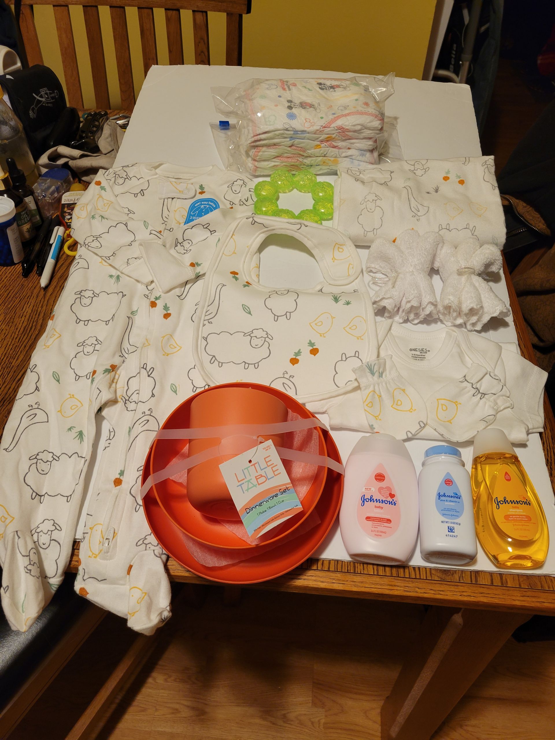 Decorative basket holding tissues and baby care items, with a white front panel and yellow sides