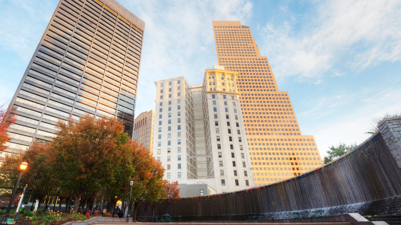 a waterfall is surrounded by tall buildings in a city