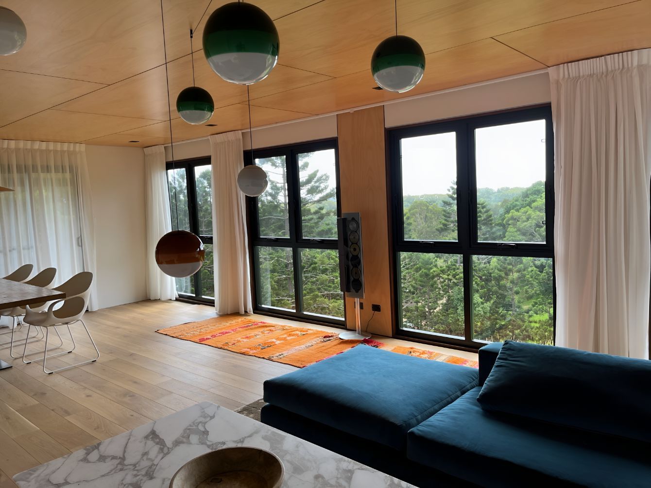 A Living Room With a Blue Couch and Lots of Windows — Newcastle Curtains And Blinds In Warners Bay, NSW