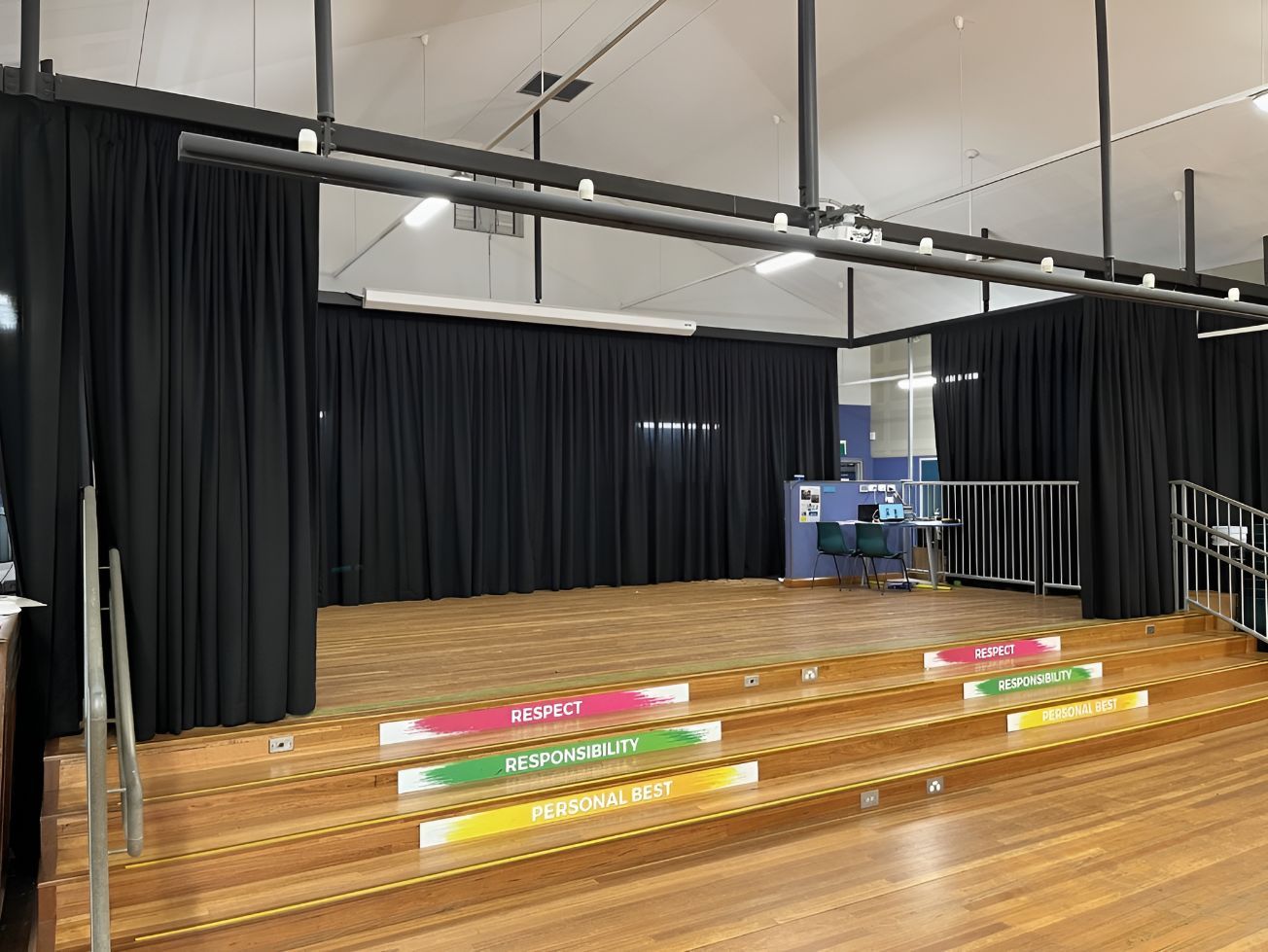 A Living Room With a Table , Chair , Rug and Curtains — Newcastle Curtains And Blinds In Warners Bay, NSW