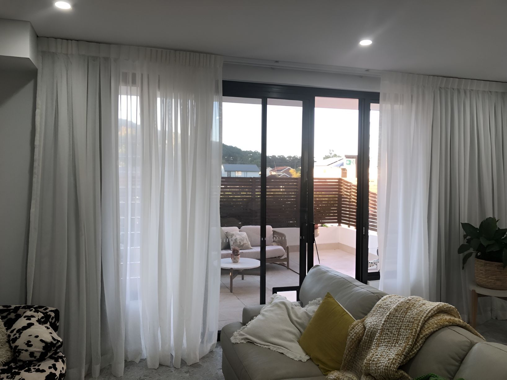 Sheer blinds hung up in lounge area looking out to a patio — Newcastle Curtains And Blinds In Warners Bay, NSW
