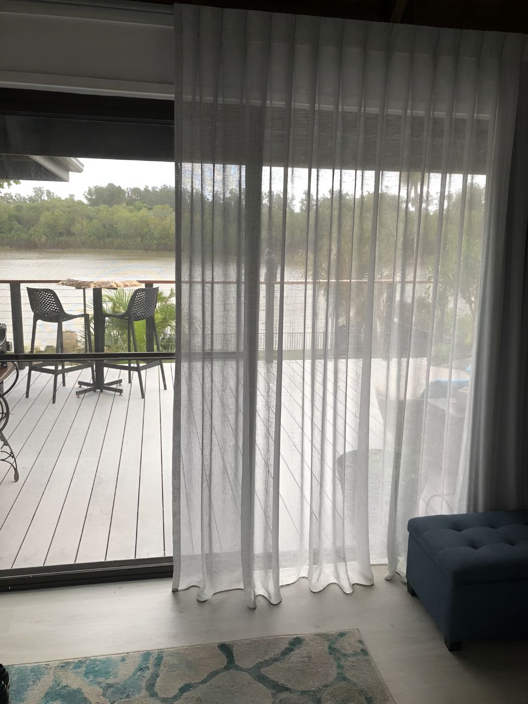 A Living Room With a Sliding Glass Door and White Curtains — Newcastle Curtains And Blinds In Merewether, NSW