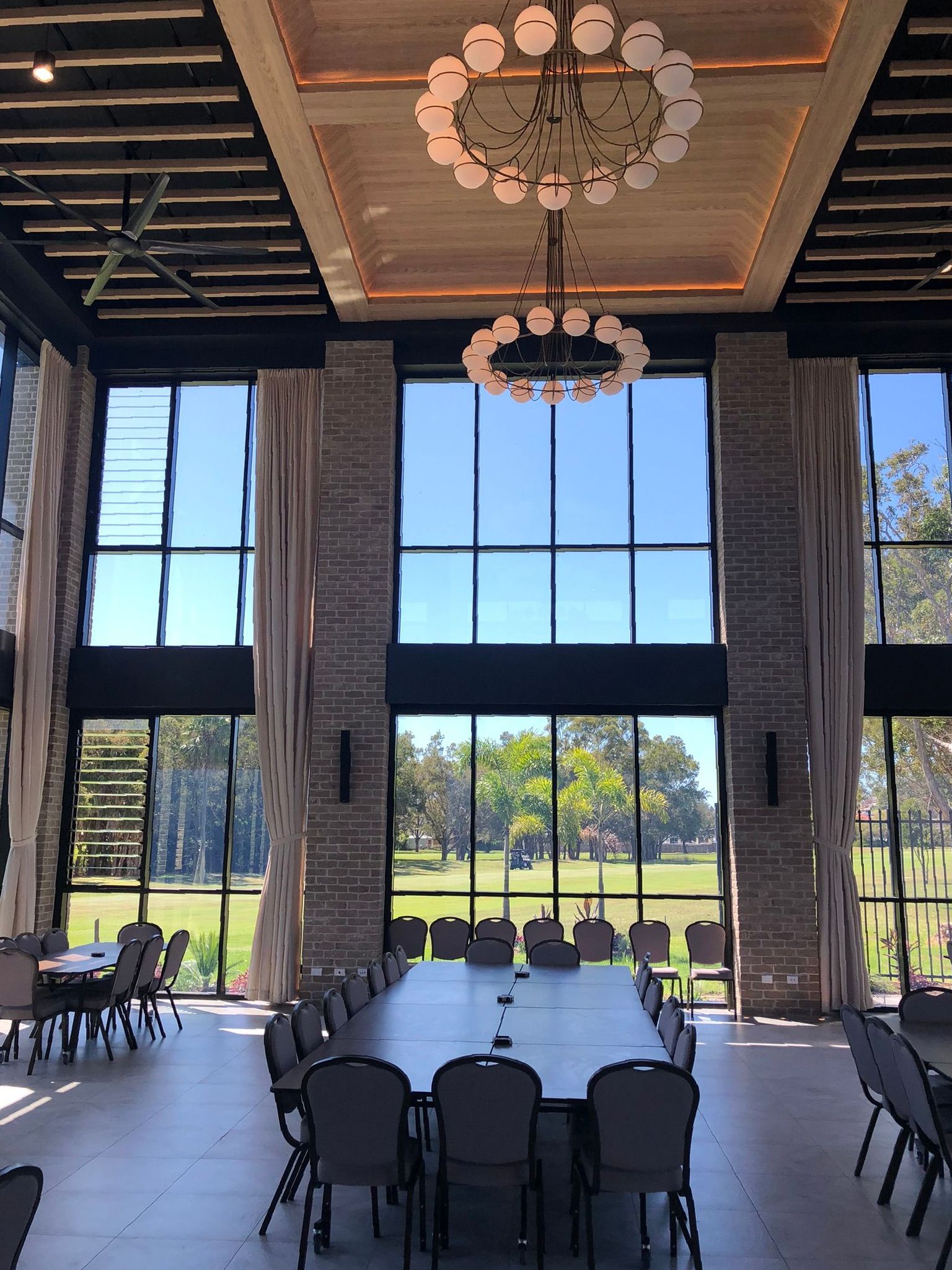 A Large Dining Area in Restaurant with large windows and curtains  — Newcastle Curtains And Blinds In Warners Bay, NSW